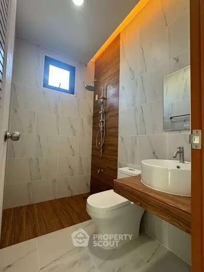 Modern bathroom with elegant tile design and sleek fixtures