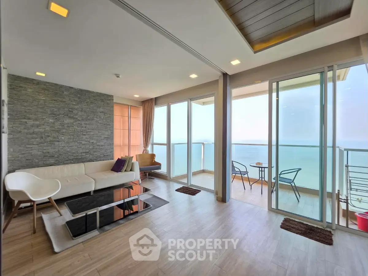 Stunning living room with panoramic ocean view and spacious balcony in modern apartment.