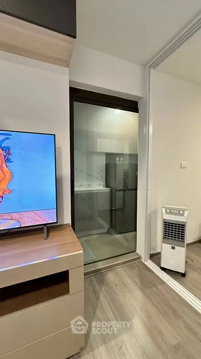 Modern living room with sleek TV stand and glass sliding door