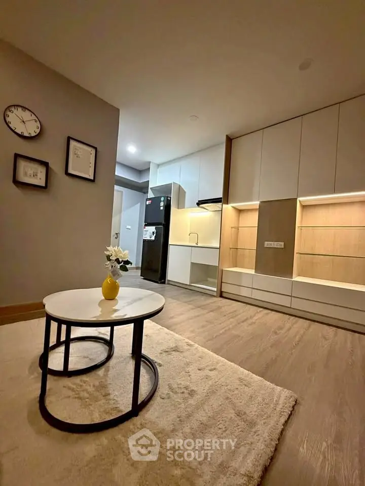 Modern living room with stylish furniture and open kitchen layout in a cozy apartment.