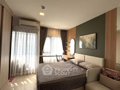 Modern bedroom with stylish decor, large window, and cozy seating area, perfect for relaxation and comfort.