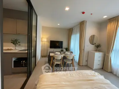 Modern studio apartment with seamless open layout, featuring a cozy bedroom area, integrated kitchen, and a charming dining space with abundant natural light.