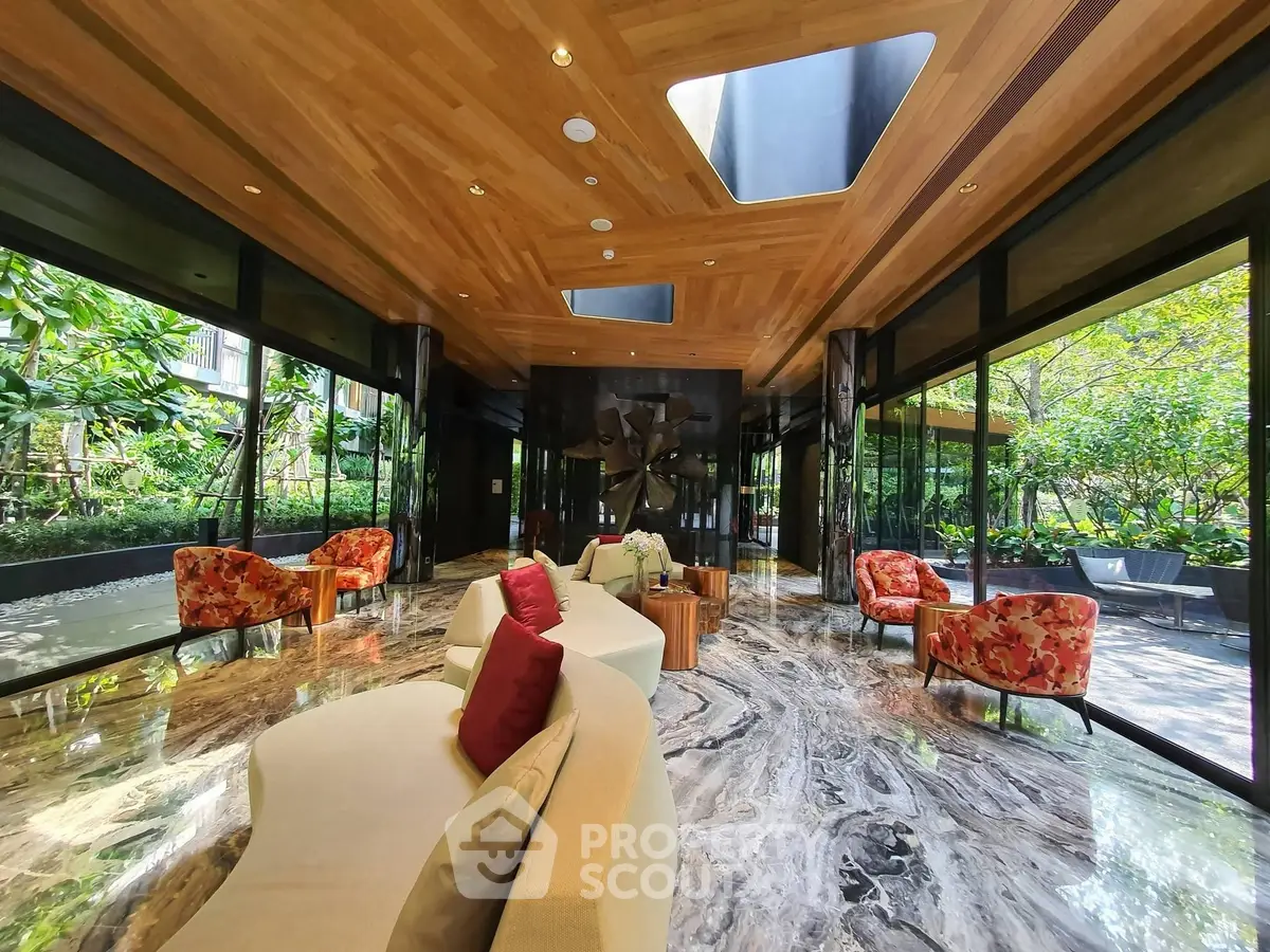Luxurious lobby with elegant seating and lush garden views, featuring a stunning marble floor and wooden ceiling.