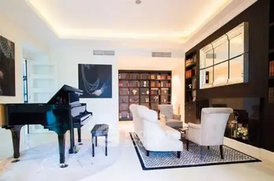 Luxurious living room with grand piano and elegant seating area, perfect for entertaining.