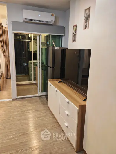 Modern living room with sleek furniture and balcony access