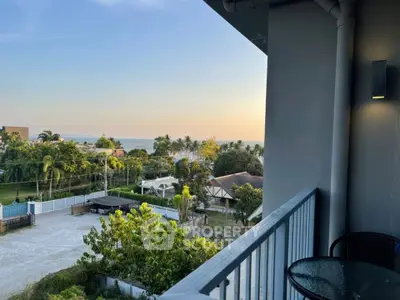 Stunning balcony view with lush greenery and distant ocean horizon
