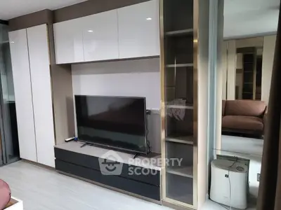 Modern living room with sleek TV unit and ample storage space