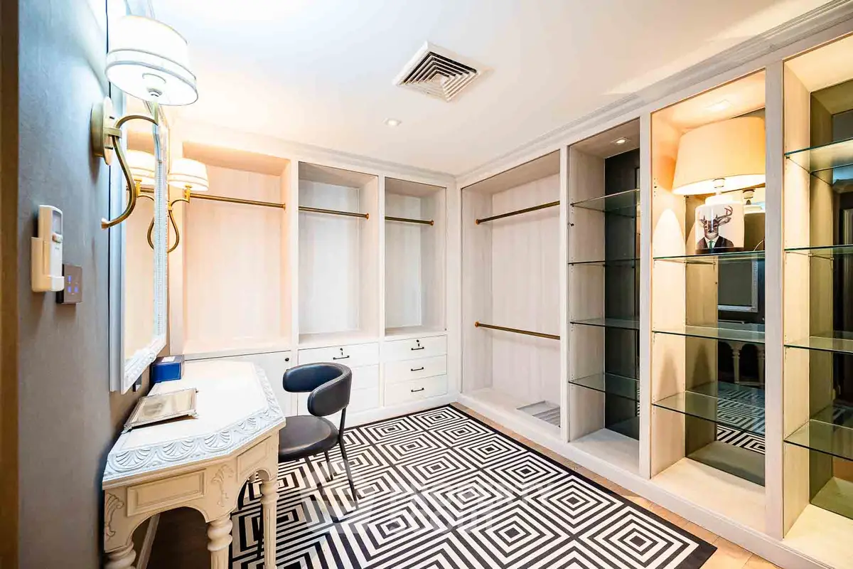 Luxurious walk-in closet with elegant lighting and stylish decor