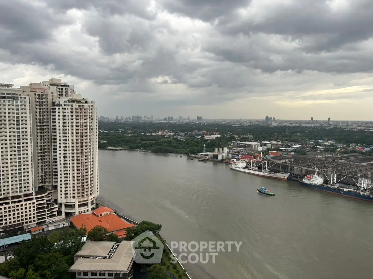Stunning riverfront view from high-rise building with cityscape in the background.