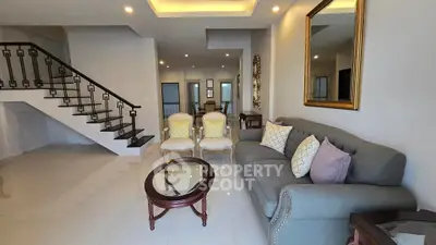 Spacious modern living room with elegant staircase and stylish furniture