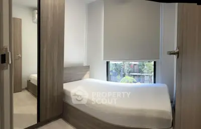 Cozy modern bedroom with large window and minimalist design