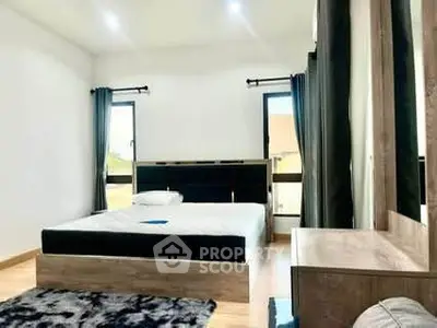 Spacious modern bedroom with large windows and stylish decor