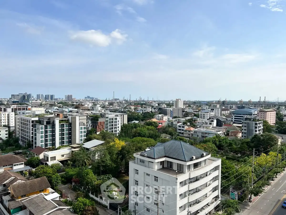 Stunning cityscape view showcasing urban skyline and residential buildings under a clear blue sky.