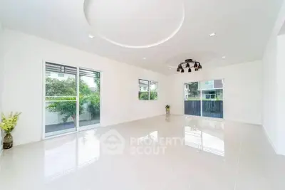 Spacious modern living room with large windows and elegant lighting