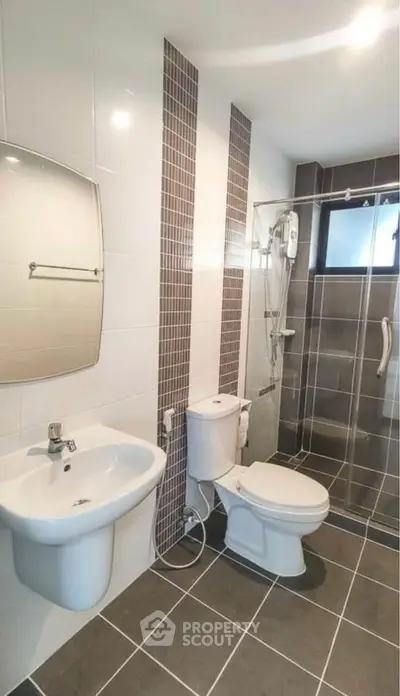 Modern bathroom with sleek tiles and shower area in contemporary apartment