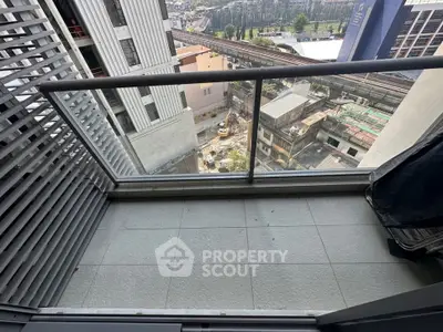 Modern balcony with city view and glass railing in urban apartment