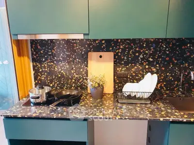 Modern kitchen with terrazzo countertop and sleek cabinetry