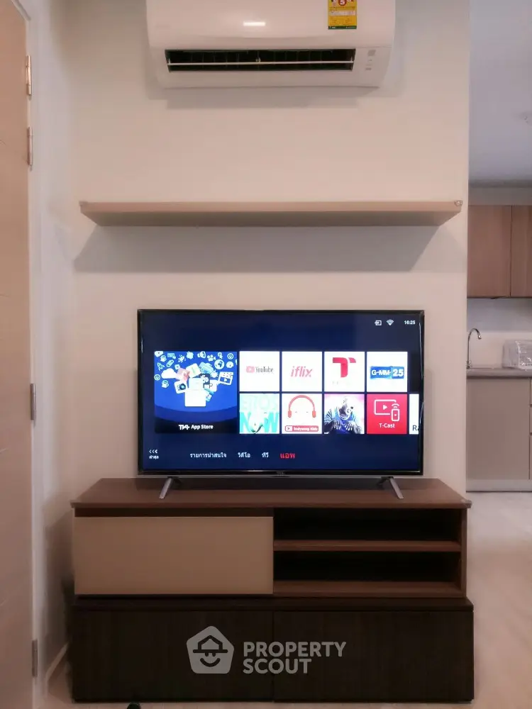 Modern living room with TV and air conditioning unit, sleek furniture design