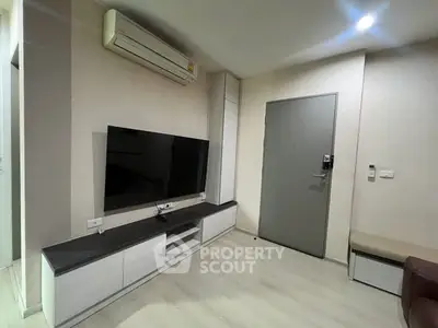 Modern living room with sleek TV unit and air conditioning