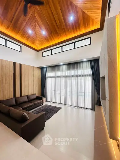 Luxurious living room with high wooden ceiling and elegant decor