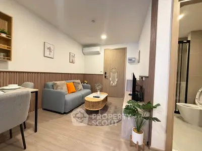 Modern living room with cozy seating and stylish decor in a contemporary apartment.