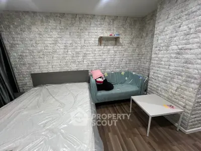 Cozy bedroom with modern decor and stylish brick accent wall