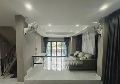 Spacious living room with modern decor and large windows for natural light.