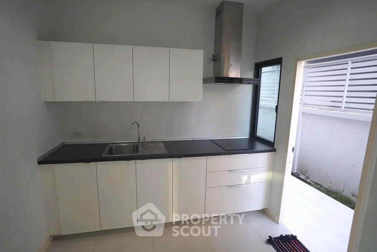 Modern kitchen with sleek cabinetry and stainless steel appliances in a bright, minimalist design.