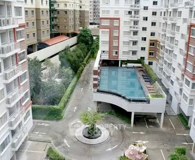 Modern apartment complex with elevated pool and lush greenery