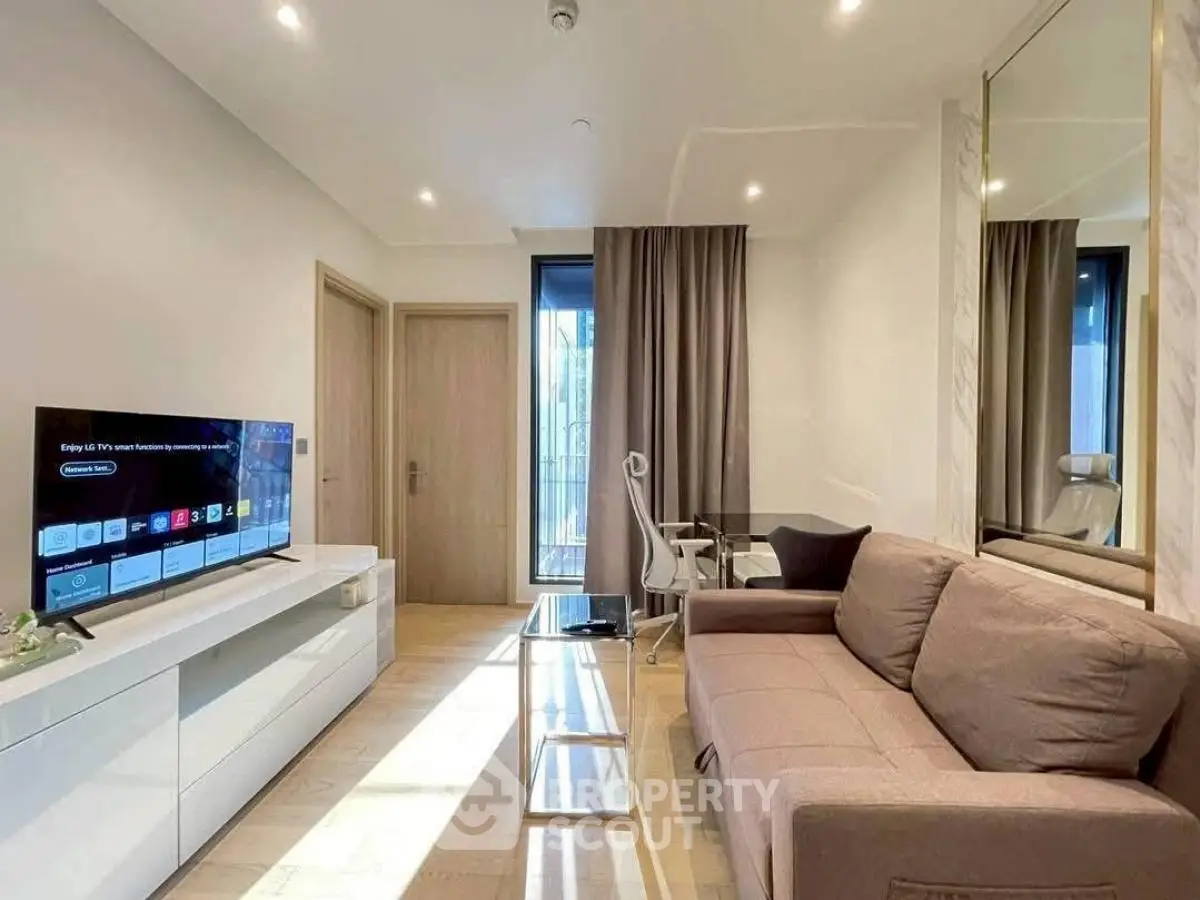 Modern living room with sleek furniture and large TV, perfect for relaxation and entertainment.