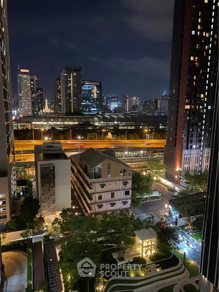 Stunning cityscape view from high-rise apartment at night, showcasing urban skyline and vibrant lights.