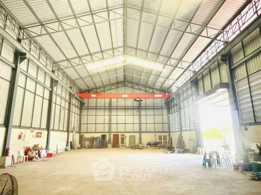 Spacious industrial warehouse with high ceilings and ample natural light.