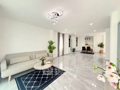 Spacious modern living room with elegant decor and open dining area