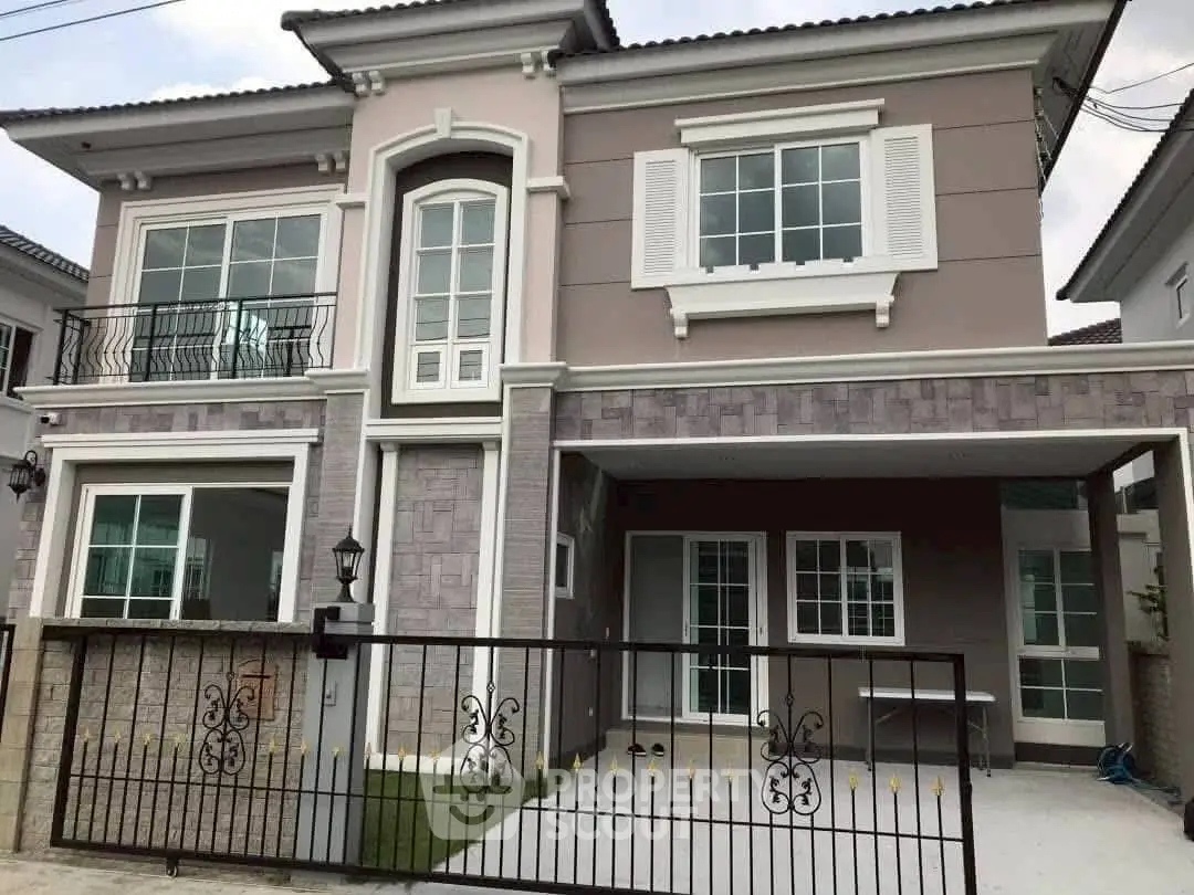 Elegant two-story house with modern facade and spacious driveway in a serene neighborhood.
