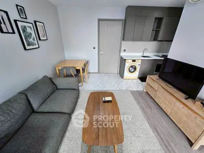 Modern living room with sleek furniture and integrated kitchen appliances