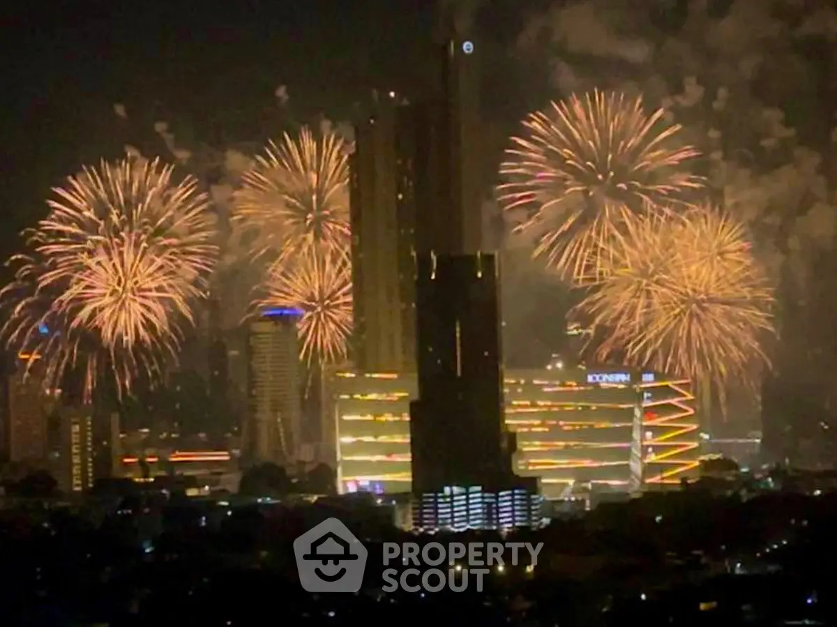 Spectacular city skyline with fireworks illuminating the night sky, highlighting modern architecture.