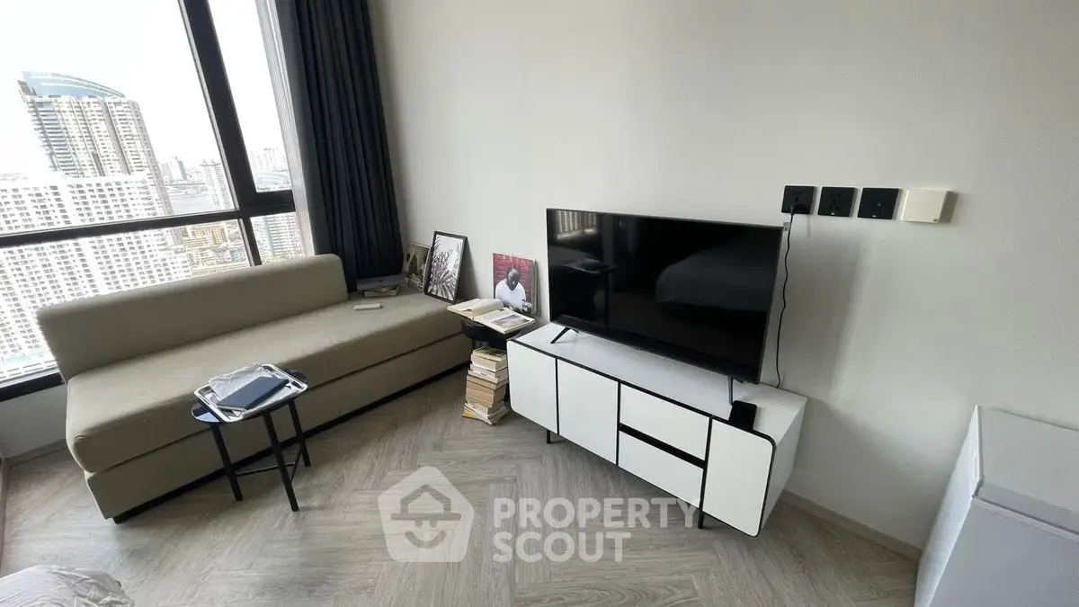 Modern living room with city view, sleek furniture, and natural light.