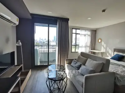 Modern studio apartment with city view, featuring cozy living area and stylish decor.