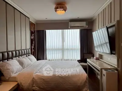 Luxurious bedroom with elegant decor, featuring a large bed, stylish lighting, and a wall-mounted TV.