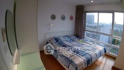 Cozy bedroom with large window offering stunning city views, featuring a comfortable bed and modern decor.