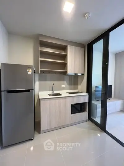 Modern kitchen with sleek cabinetry and built-in appliances in a stylish apartment.