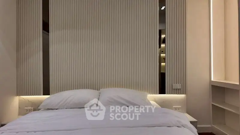 Modern bedroom with elegant lighting and minimalist design, perfect for relaxation and comfort.