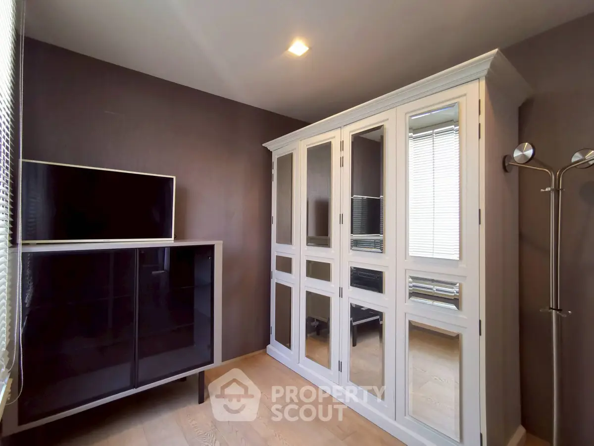 Stylish bedroom with elegant wardrobe and modern TV cabinet