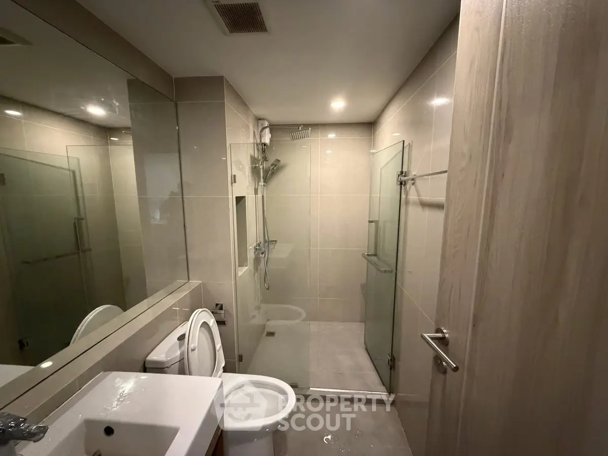 Modern bathroom with glass shower and sleek fixtures