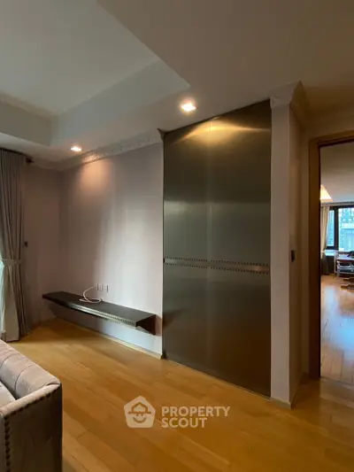 Modern living room with sleek metal storage and wooden flooring