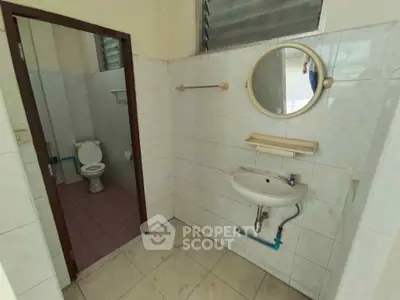 Spacious bathroom with separate toilet area and modern fixtures.