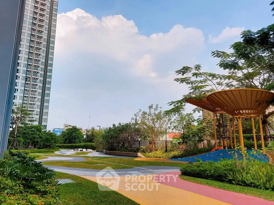 Modern residential building with landscaped garden and play area, perfect for family living.