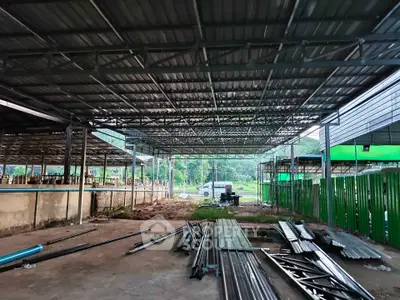 Spacious industrial warehouse with metal roofing and open layout, ideal for storage or manufacturing purposes.