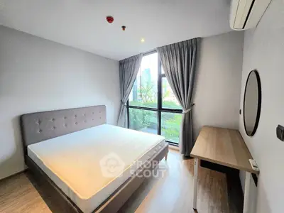 Modern bedroom with large window and stylish decor in urban apartment