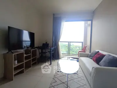 Modern living room with large TV and balcony view